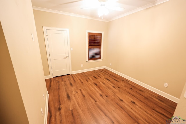 empty room with hardwood / wood-style flooring, ceiling fan, and crown molding