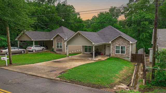 view of front of property featuring a lawn and a carport