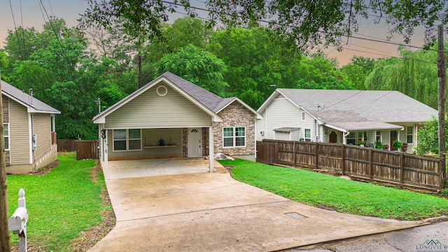 view of front of home featuring a carport and a lawn