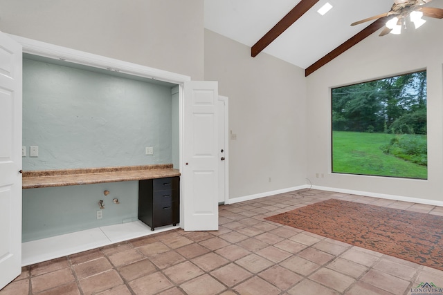 kitchen with beamed ceiling, ceiling fan, built in desk, and high vaulted ceiling