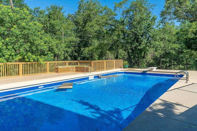 view of pool with a diving board