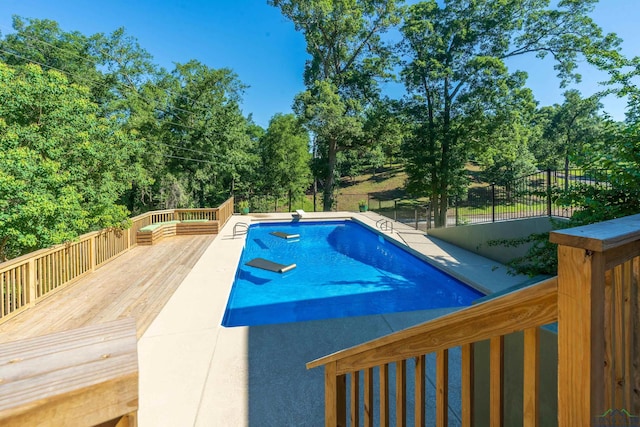 view of swimming pool with a deck