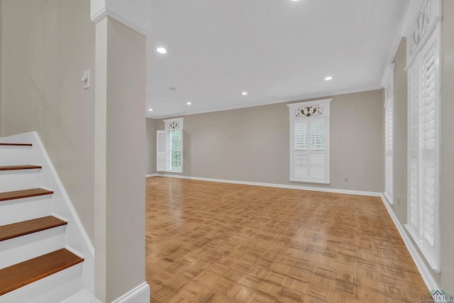 interior space with light parquet floors and ornamental molding