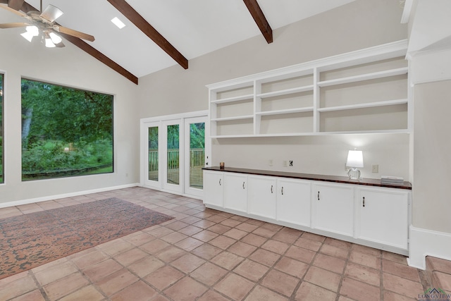 interior space featuring high vaulted ceiling, french doors, ceiling fan, beam ceiling, and white cabinetry