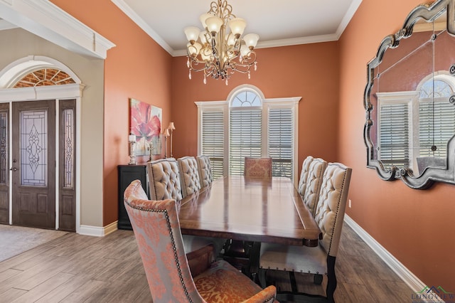 dining room with a notable chandelier, plenty of natural light, and ornamental molding