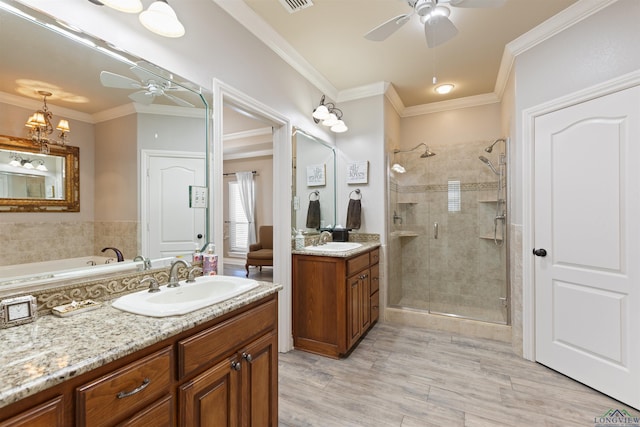 bathroom featuring a sink, ornamental molding, a stall shower, and ceiling fan