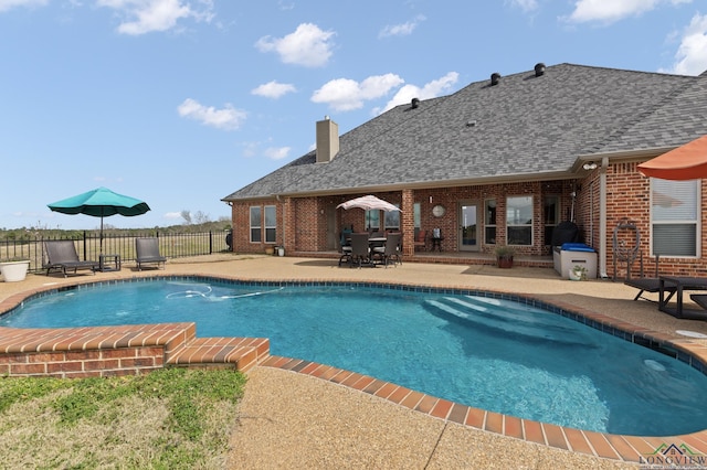 view of pool with a fenced in pool, a patio area, and fence