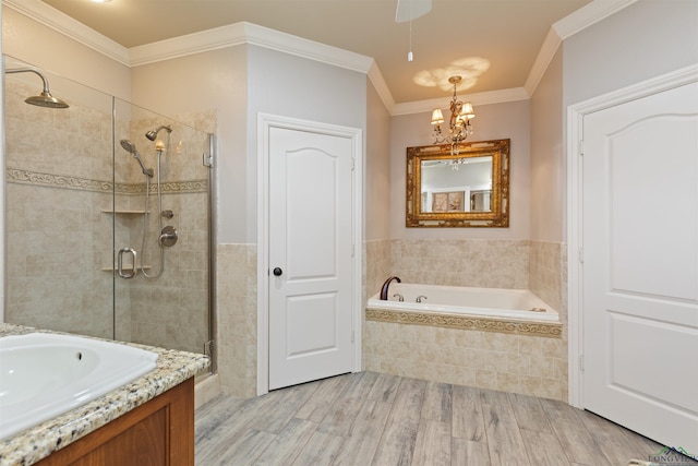 full bathroom featuring crown molding, a garden tub, a stall shower, wood finished floors, and a notable chandelier