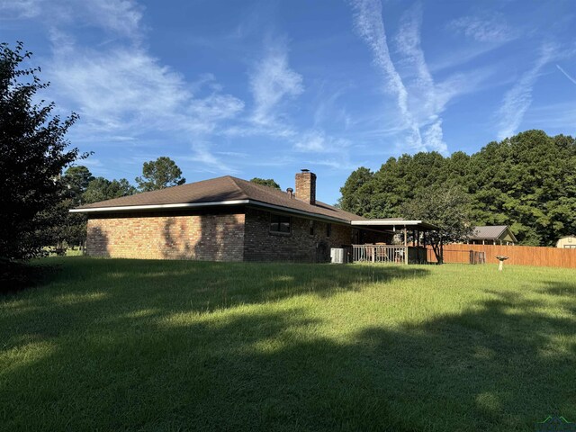 view of side of home with a yard