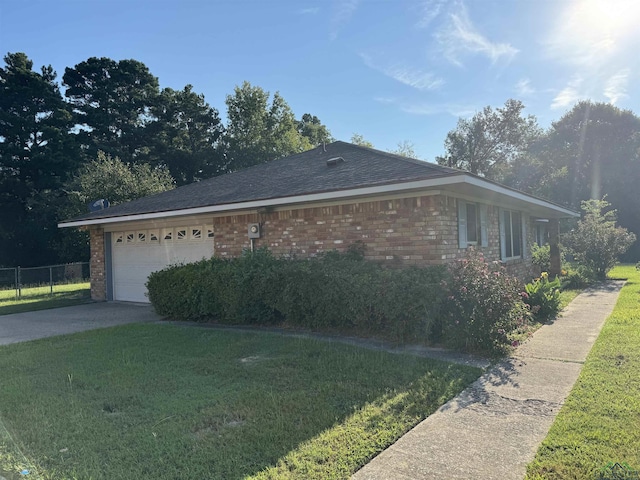 view of side of property with a garage and a lawn