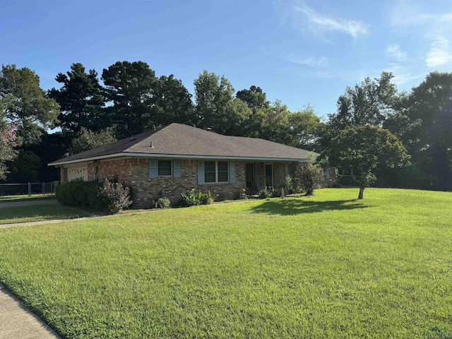 ranch-style home with a front yard and a garage