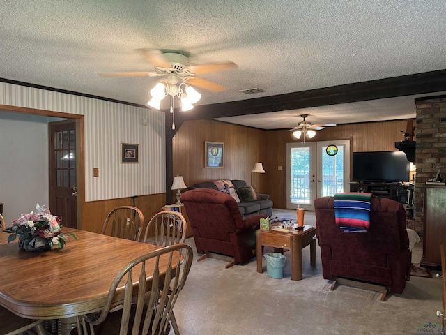 dining room with beamed ceiling, french doors, a textured ceiling, and ceiling fan