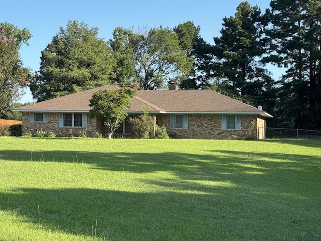 ranch-style home with a front lawn