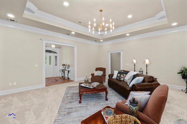 carpeted living room with ornamental molding and a tray ceiling