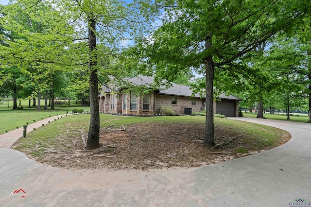 single story home with a garage and a front lawn