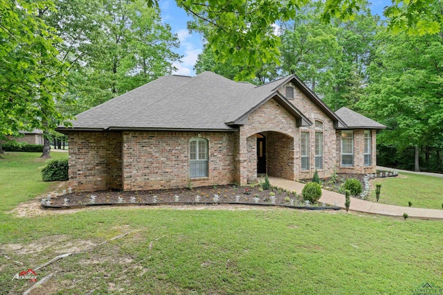 french provincial home featuring a front yard