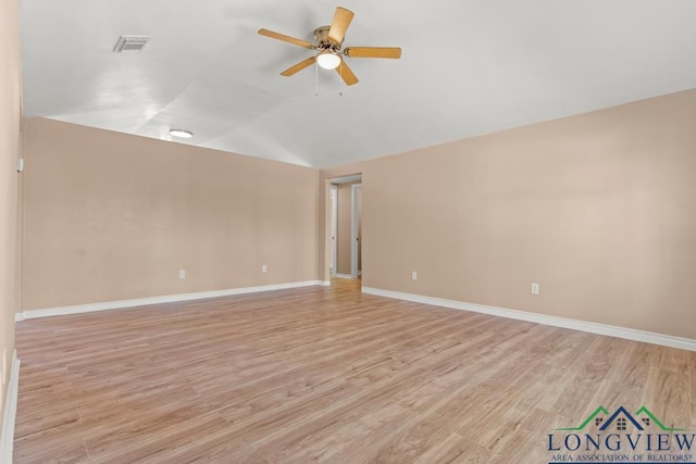 unfurnished room with visible vents, light wood-style flooring, a ceiling fan, and vaulted ceiling