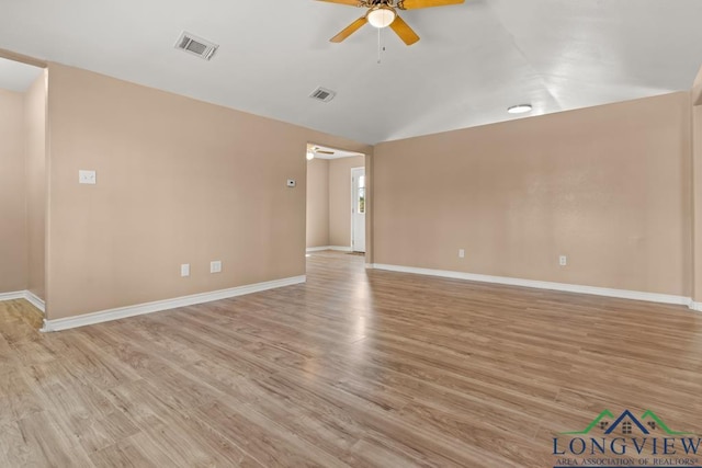 spare room with visible vents, light wood-type flooring, and a ceiling fan