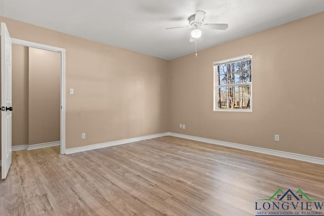 interior space with baseboards, light wood-style flooring, and a ceiling fan