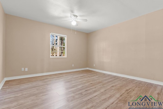 empty room featuring ceiling fan, baseboards, and light wood-style floors