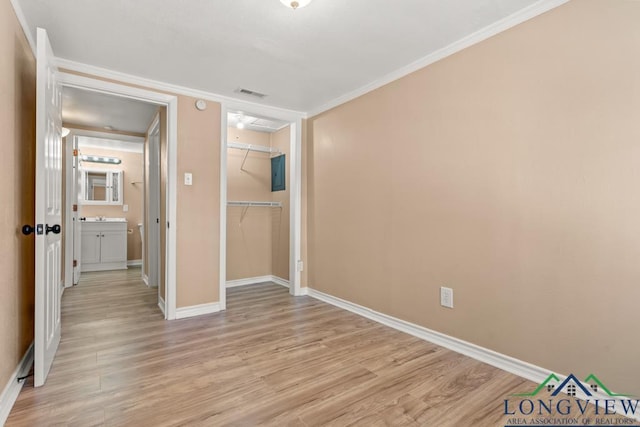 unfurnished bedroom with visible vents, light wood-type flooring, baseboards, and ornamental molding