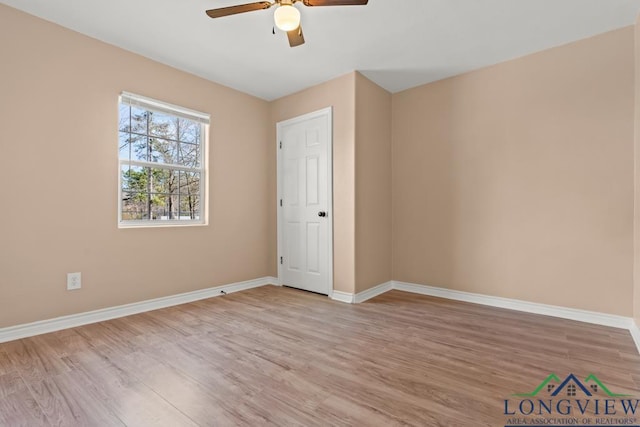 unfurnished bedroom featuring a ceiling fan, wood finished floors, and baseboards