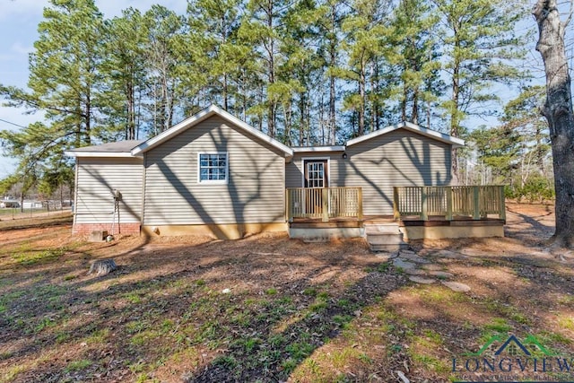 rear view of house with a wooden deck