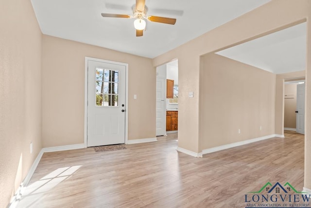 foyer with ceiling fan, baseboards, and light wood-style flooring