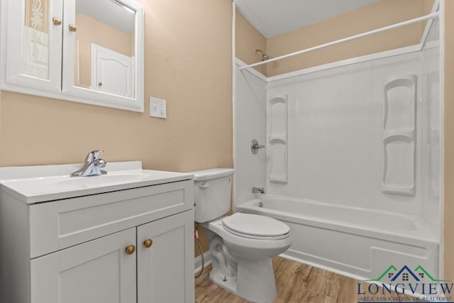 full bath featuring toilet, tub / shower combination, vanity, and wood finished floors