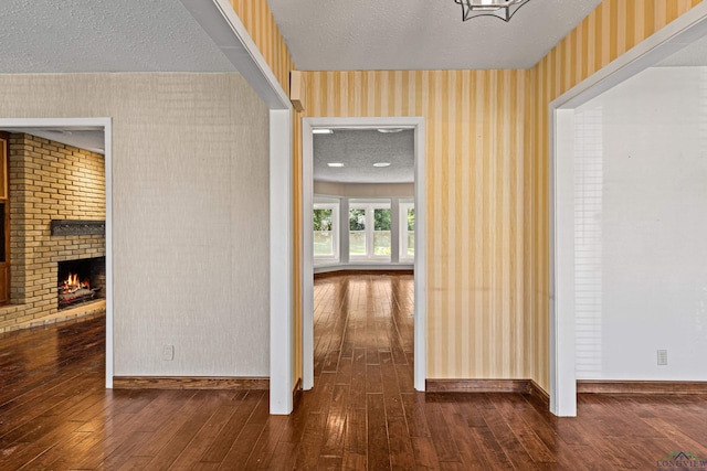 hall featuring dark hardwood / wood-style floors and a textured ceiling