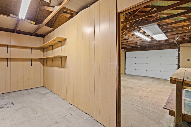 garage featuring wood walls