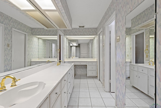 bathroom featuring tile patterned floors, vanity, and a textured ceiling