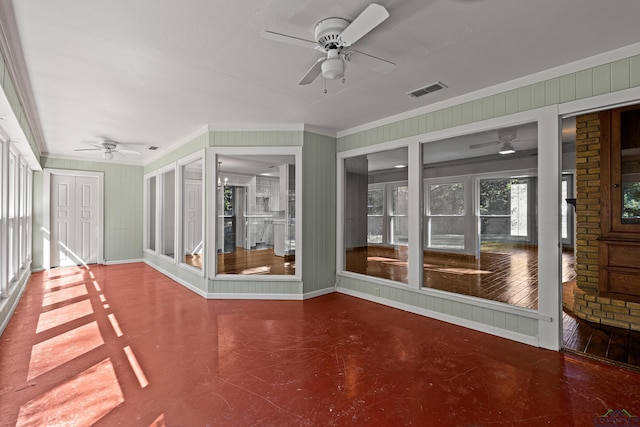 unfurnished sunroom featuring ceiling fan