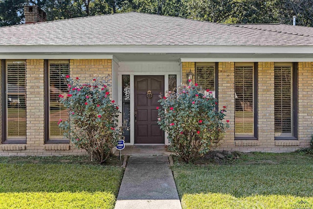 property entrance with a yard