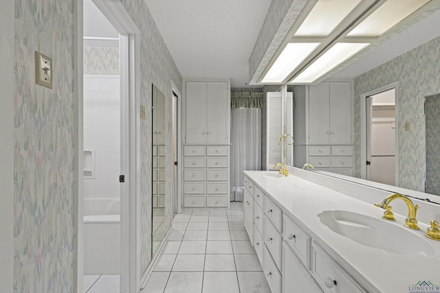 bathroom with vanity, a textured ceiling, and tile patterned floors