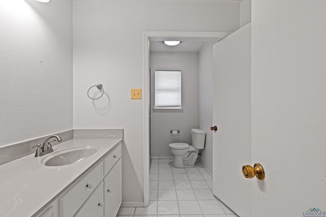 bathroom with tile patterned floors, vanity, and toilet