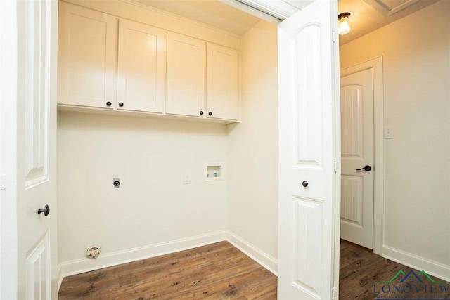 laundry area featuring baseboards, hookup for a washing machine, cabinet space, and wood finished floors