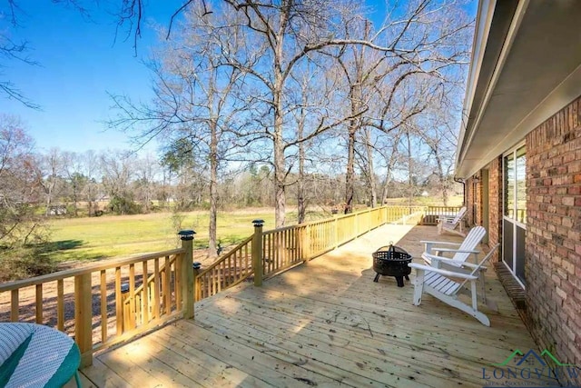 wooden terrace with an outdoor fire pit
