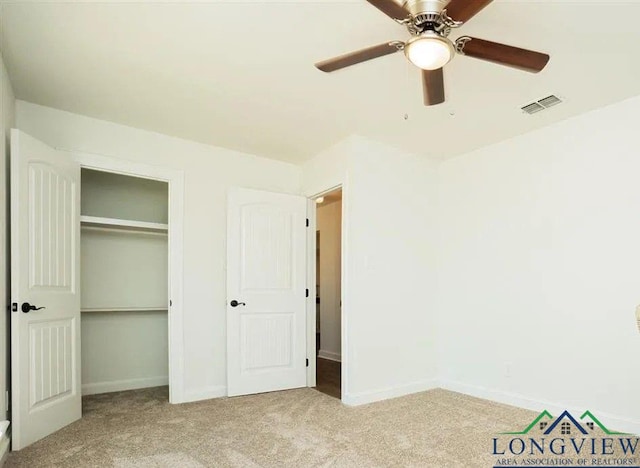 unfurnished bedroom with visible vents, carpet flooring, baseboards, and a closet