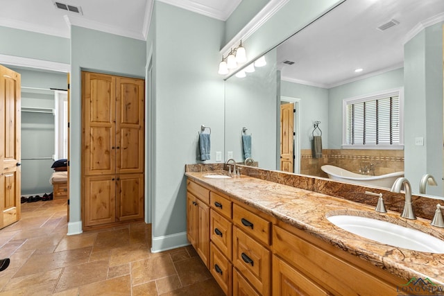 12265 Sable Ln, Whitehouse, TX 75791 - full bath featuring double vanity, a closet, a bathtub, ornamental molding, and stone tile flooring