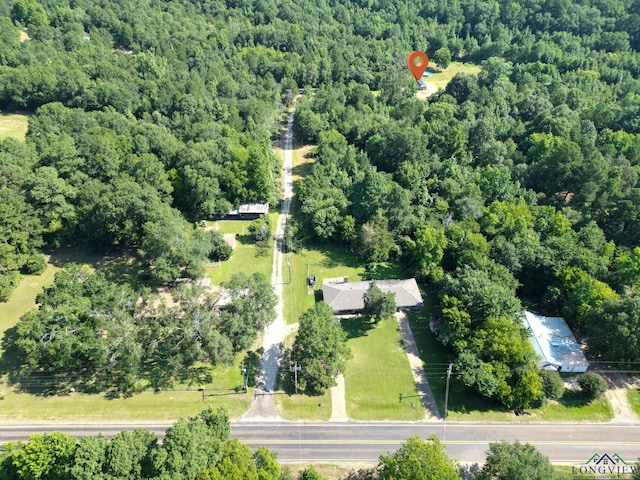 1203 Vesta Ave, Gladewater, TX 75647 - aerial overview of property's location featuring a heavily wooded area