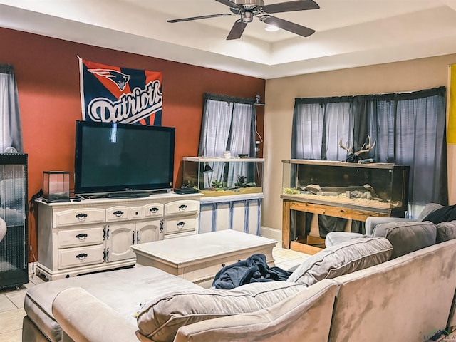 203 Reynolds St, Pittsburg, TX 75686 - living area featuring light tile patterned floors, a ceiling fan, and a raised ceiling