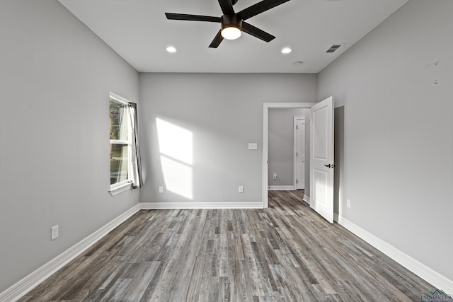 unfurnished room with ceiling fan and wood-type flooring