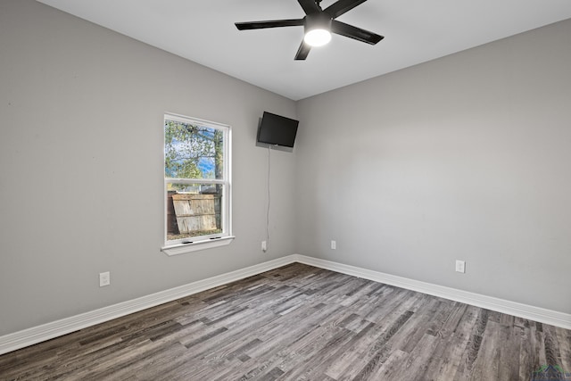 spare room with ceiling fan and wood-type flooring