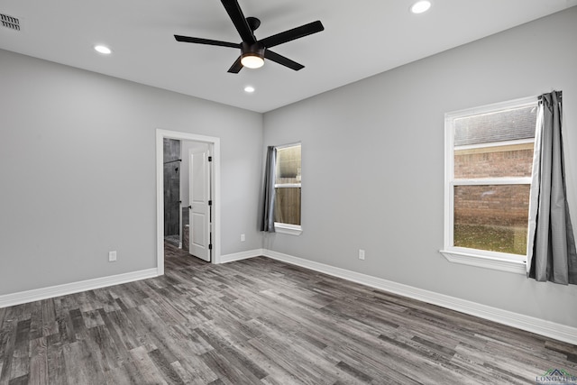 unfurnished room featuring dark hardwood / wood-style floors and ceiling fan