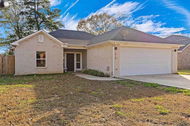 single story home featuring a garage and a front yard