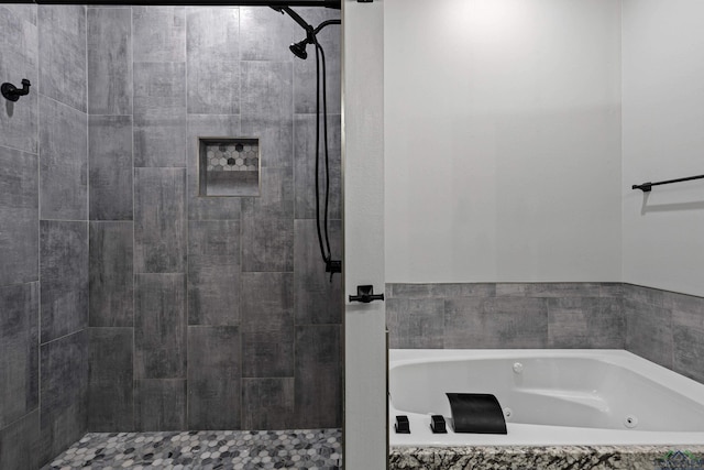 bathroom featuring shower with separate bathtub