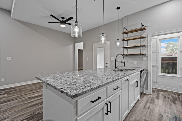 kitchen featuring ceiling fan, sink, hanging light fixtures, dark hardwood / wood-style floors, and white cabinets