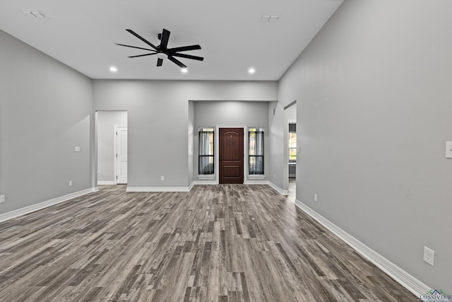 unfurnished living room featuring wood-type flooring and ceiling fan