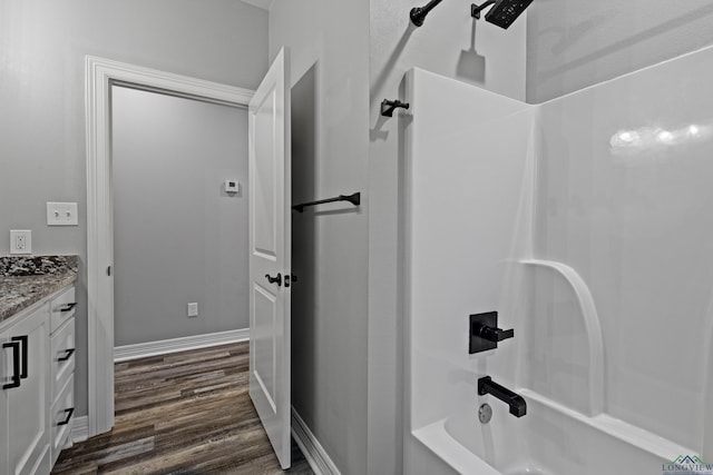 bathroom with vanity,  shower combination, and wood-type flooring